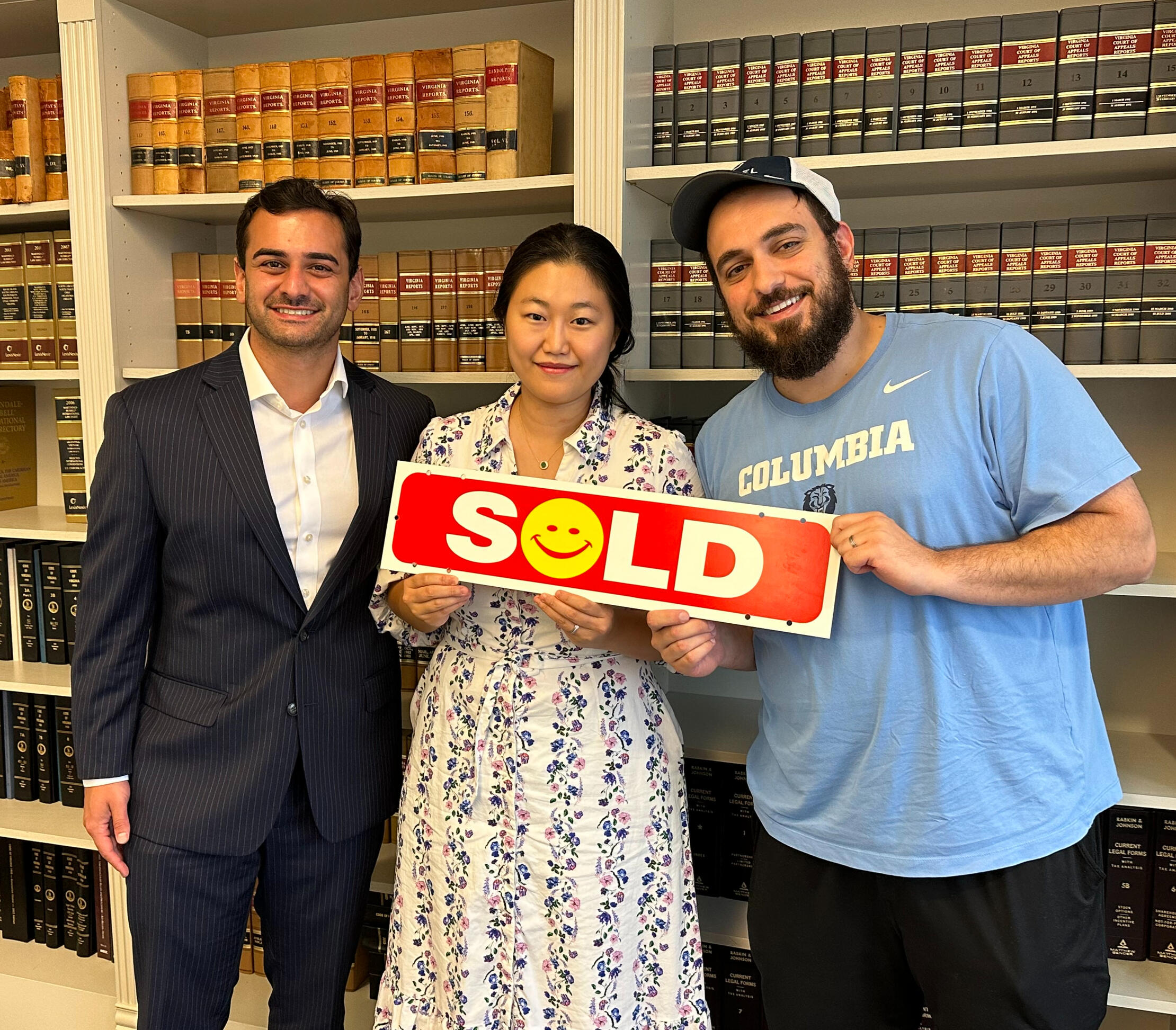 Sold with Ash Arora Ash Arora and his clients holding up a sold sign indicating that the clients just purchased a home